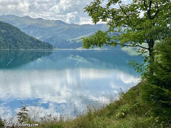 Photo Lac de Roselend : Joli jeu de reflets sur le Lac de Roselend, dans le Beaufortin. Sous les nuages, sa belle couleur turquoise se transforme en un dégradé de verts. c, Tita’s Pictures, Les Alpes, Lac de Roselend, Beaufortin, Savoie